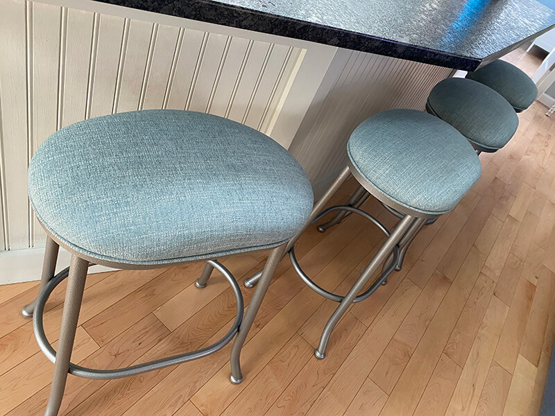Wesley Allen's Canton Modern Backless Oval Swivel Stools in Silver Metal and Blue Seat Cushion in Kitchen