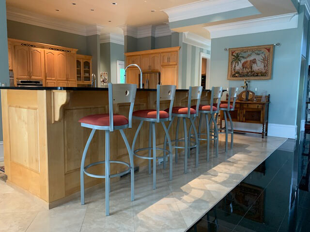 Holland's Voltaire Traditional Nickel Swivel Bar Stool with Wood Back in Customer's Traditional Kitchen with Wood Cabinets